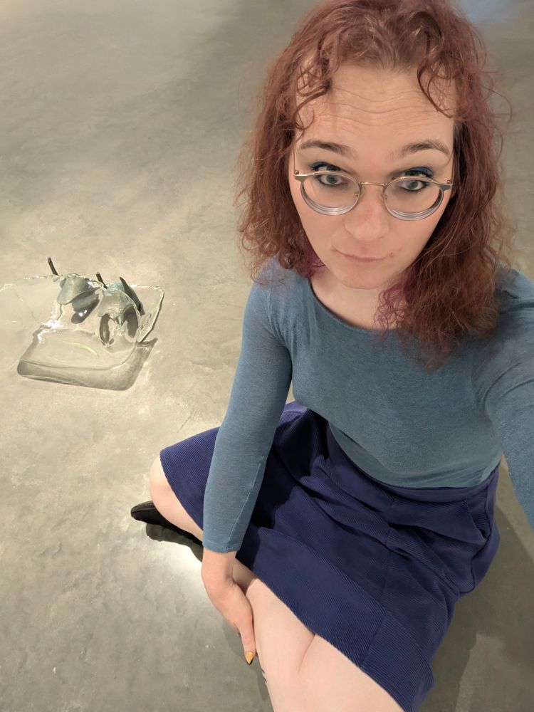 Frames dresses all in blue sitting on group nextbtk a strange brass and glass statue