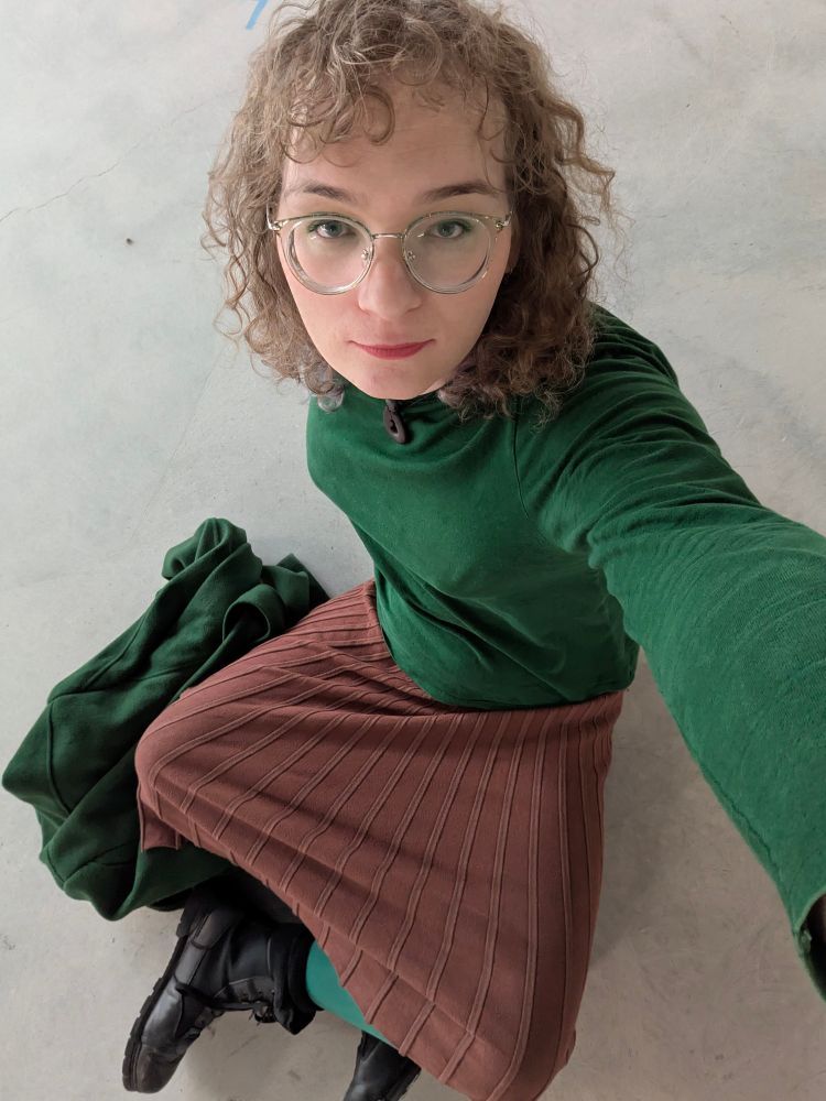 The Frames Who Sees Beauty sitting cross-legged on concrete