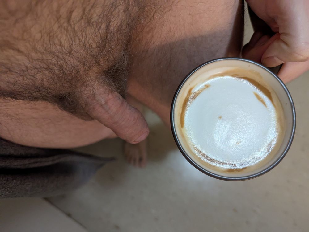 Top-down POV of me holding a latte with my dick out.