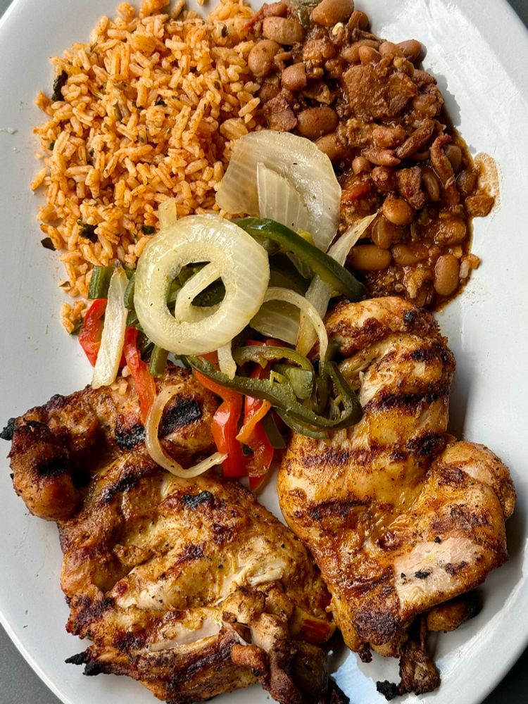 Charbroiled chicken thighs, charro beans, rajas, and Mexican rice