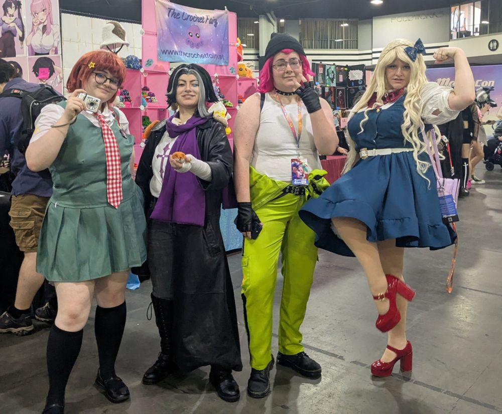 4 colorful cosplayers dressed as the characters mahiru, gundam (i will never spell it gundham), souda, and Sonia from dangan ronpa 2