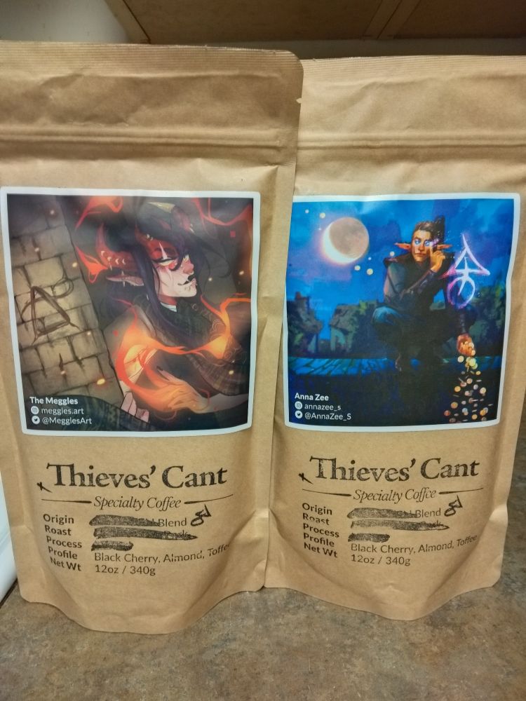 Photo of a pair of pound bags of Thieves' Cant coffee, unopened, sitting on my kitchen counter.