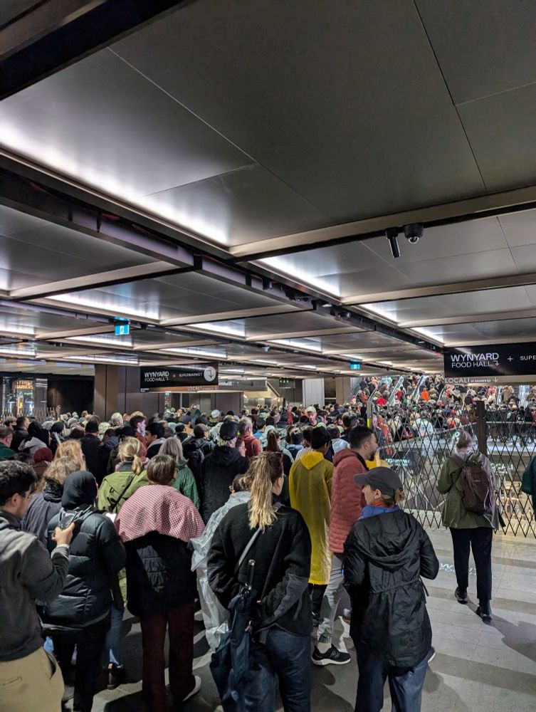 hundreds of people streaming out of Wynyard Station in Sydney