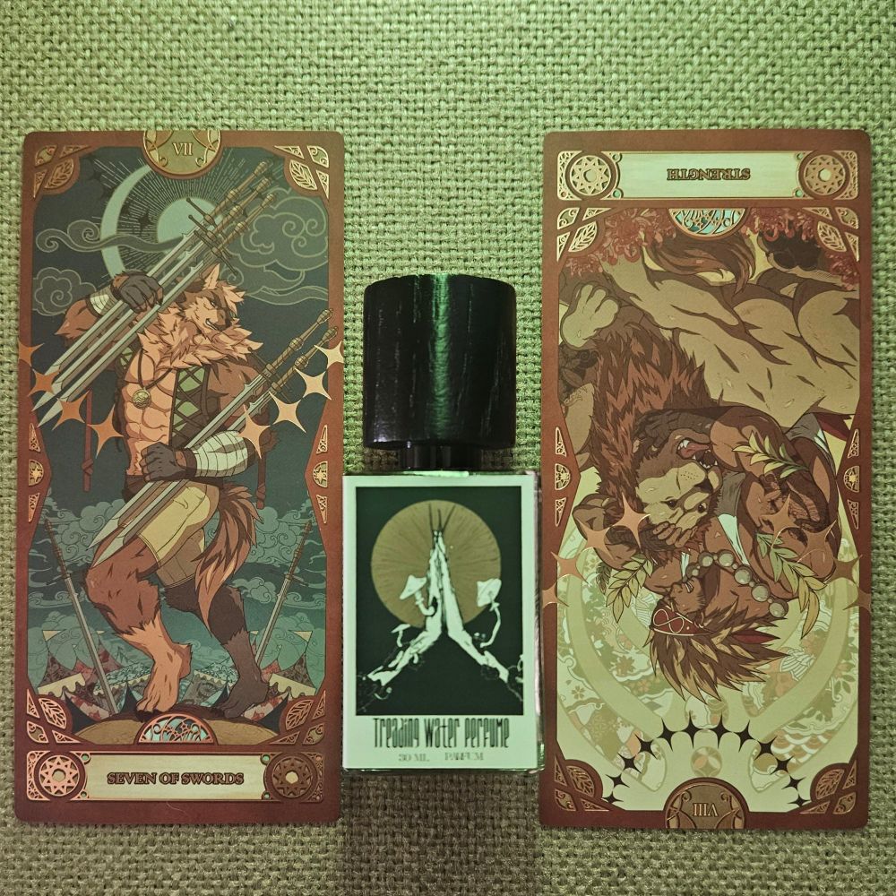 The VII of Swords and a reversed card VIII - Strength tarot straddle a bottle of mycelium by Hayden Grossman for Treading Water Perfume