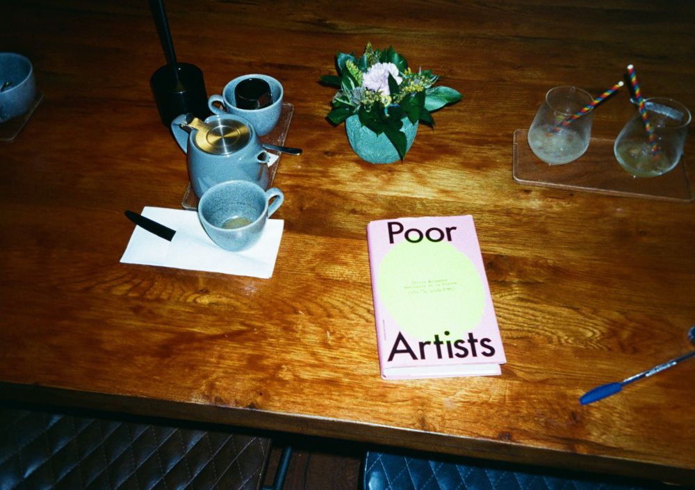 poor artists hardback on a coffee table in a cafe shot in film