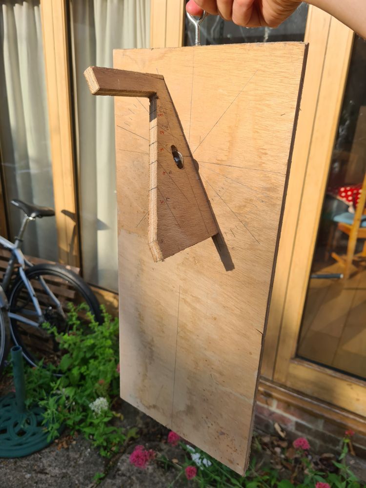 Wooden version of a Roman sundial displaying the time in unequal hours. It has been set up for the latitude of Oxford and for the sun's declination (just beyond the solstice), and the shadow of the gnomon falls roughly half way between 1 and 2 on the hour scale.  