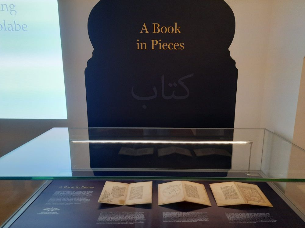 A display showing three leaves from Fifty Chapters for the Ruler on the Science of the Astrolabe (Panjah Bab-i Sultani dar Marifat Usturlab) by Rukn al-Din b. Sharaf al-Din al-Husayni al-Amuli. Qatar National Library, HC.MS.2017.0057.