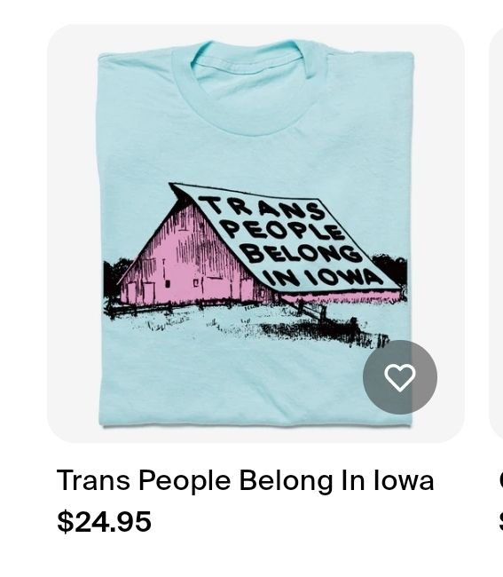 screenshot from an online shop for $24.95. it is displaying a blue t-shirt with a red barn that says "trans people belong in iowa" on the roof