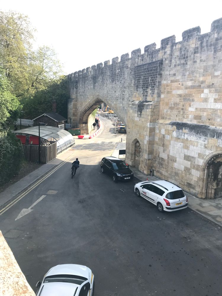 Arch made in York city walls to allow railway track to pass through. Now a road with no track