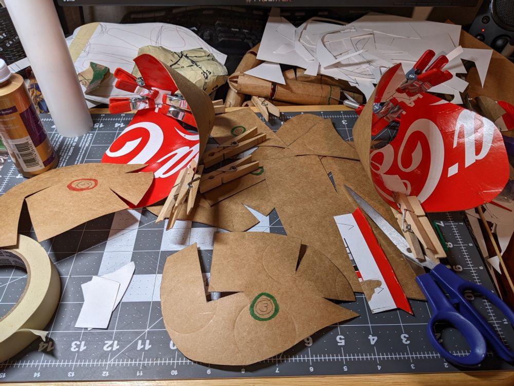 A large crafting mess of cardboard and tape and glue.