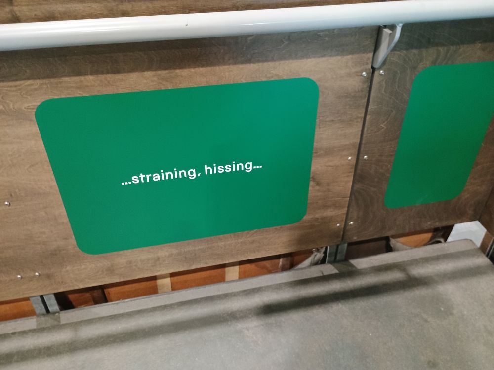 A second sign that reads "...straining, hissing..."