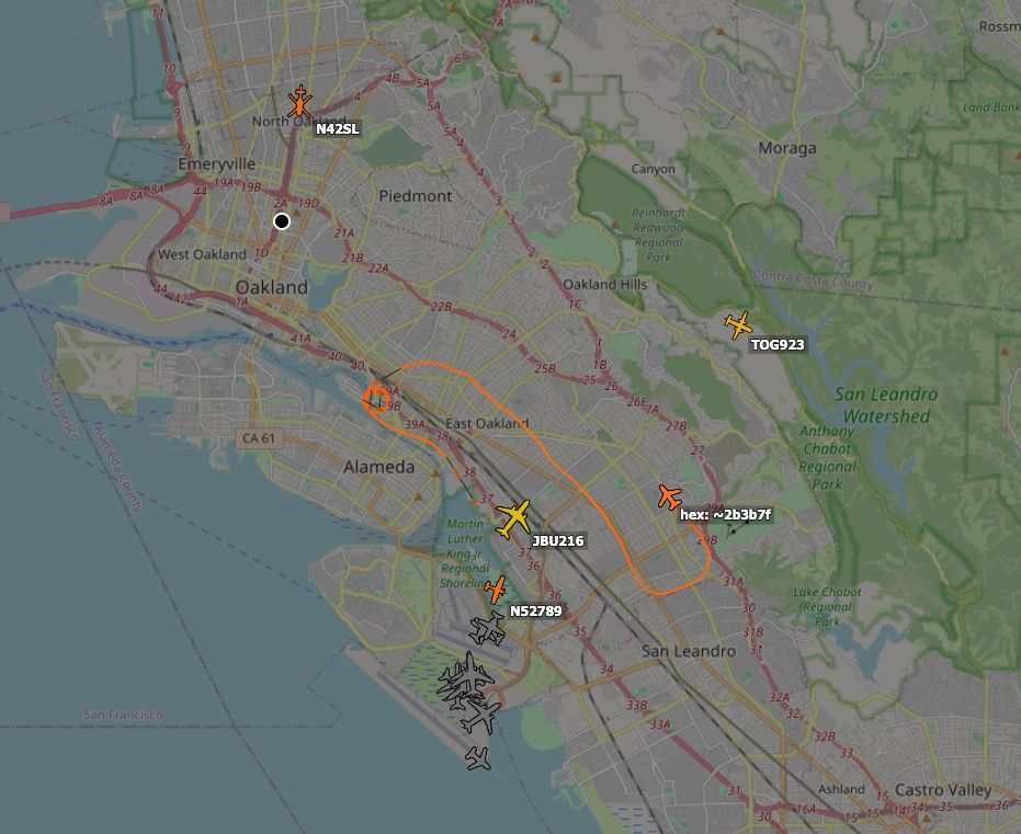 Screenshot of ADS-B exchange showing a handful of aircraft over the East Bay including a TIS-B target and N42SL, a news helicopter