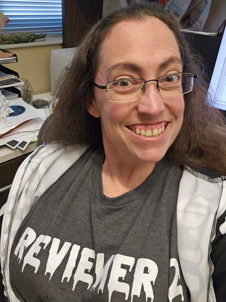 Me with the skeleton onesie zipped open to reveal a "Reviewer #2" shirt underneath.