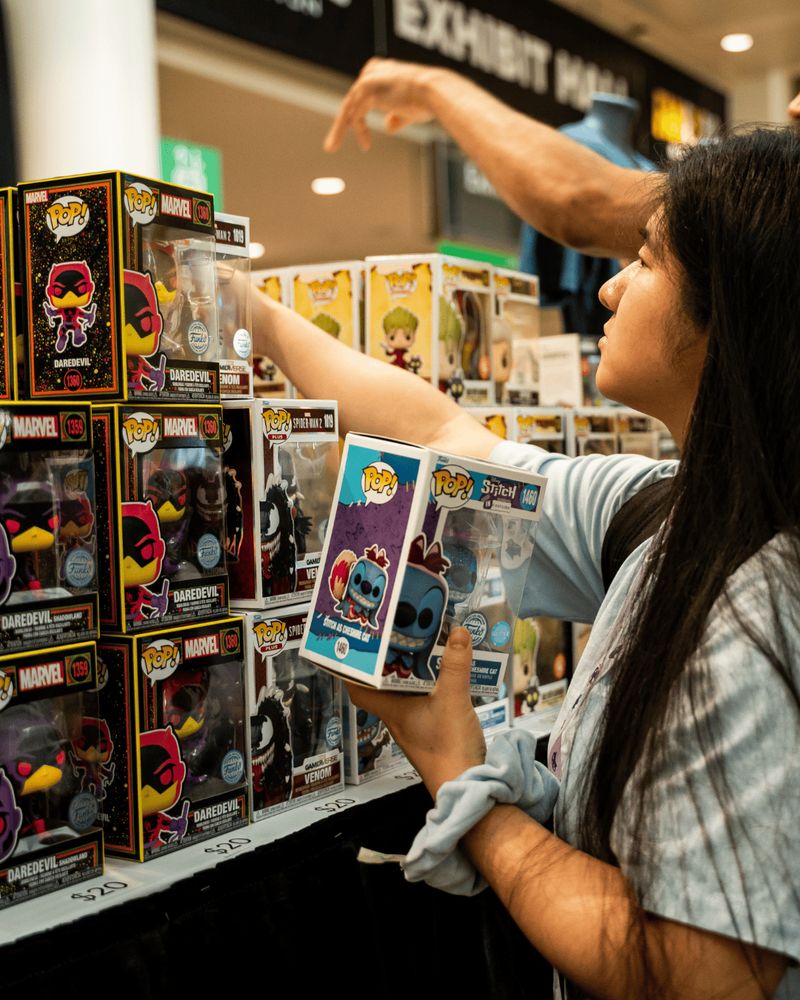 Image of fan looking at funkos at the FAN EXPO Merch booth