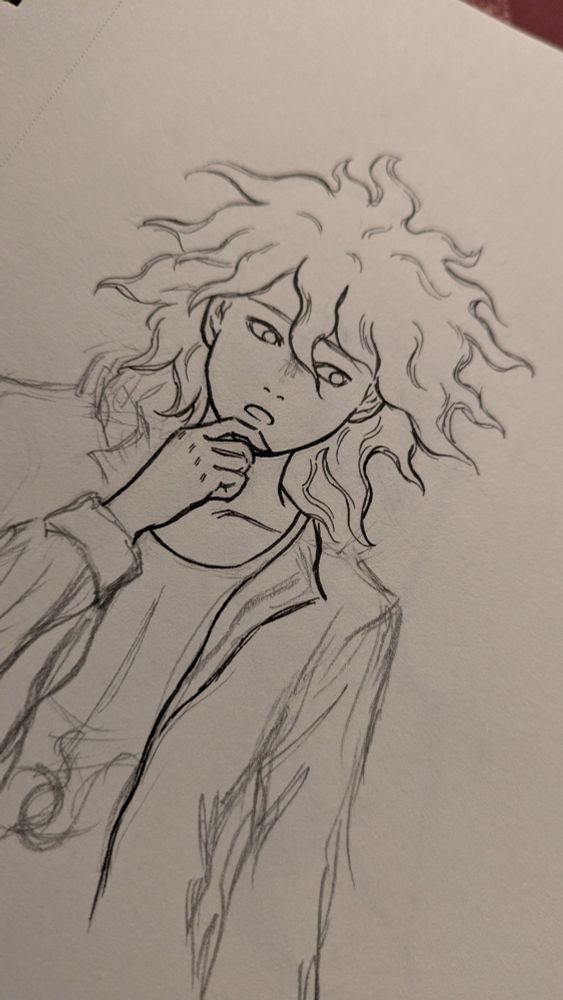 An incomplete drawing of Nagito Komaeda on paper.