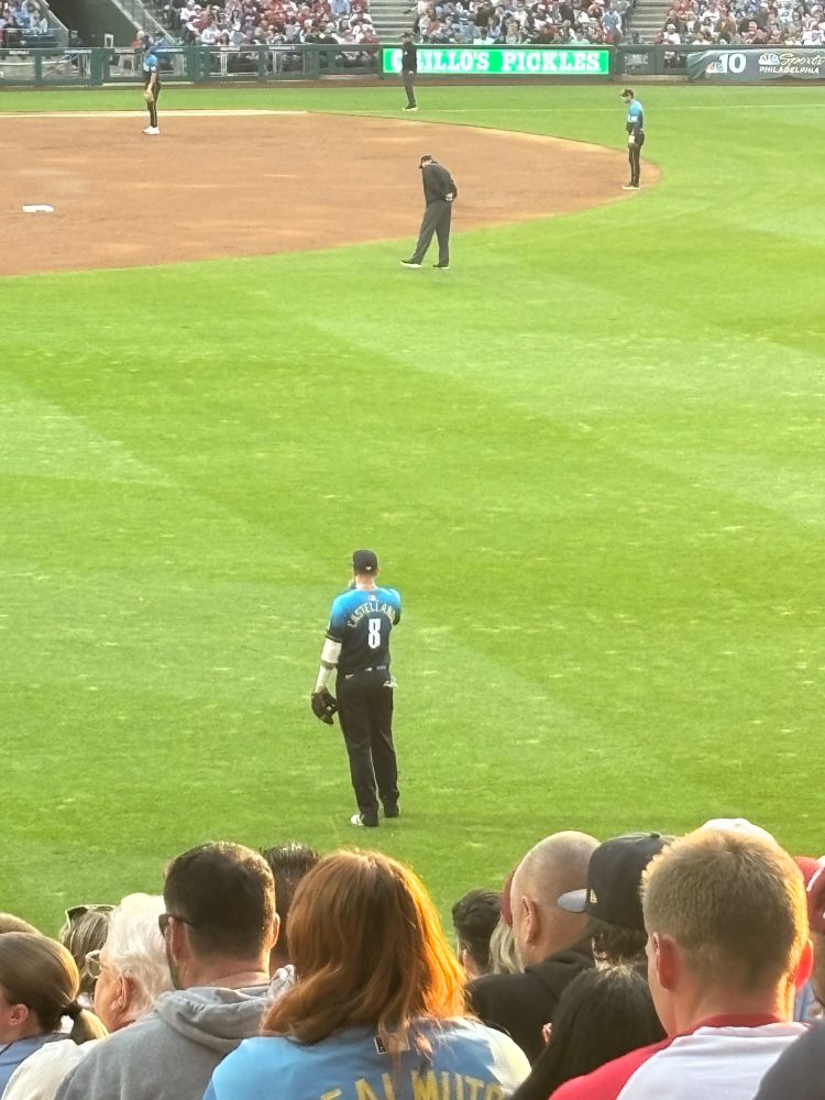 nick castellanos of the philadelphia phillies standing on the field with his back to the camera 