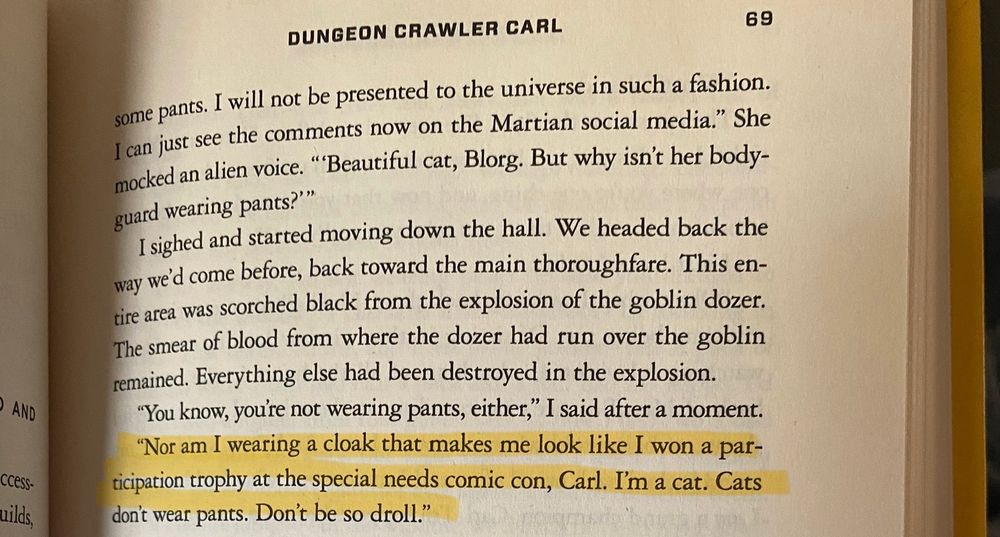 Picture of page 69 in Dungeon Crawler Carl by Matt Dinniman, with this line highlighted: “Nor am I wearing a cloak that makes me look like I won a participation trophy at the special needs comic con, Carl. I’m a cat. Cats don’t wear pants. Don’t be so droll.”