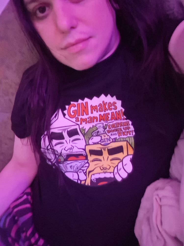 Me modeling a black t shirt with a graphic featuring Milk and Cheese, America's favorite ultraviolent dairy products, saying, "gin makes a man mean," and, "everyone booze up and riot," respectively