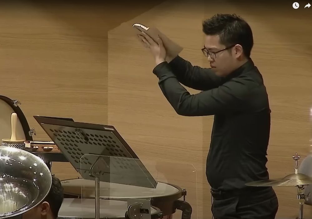 Man playing sandpaper in an orchestra