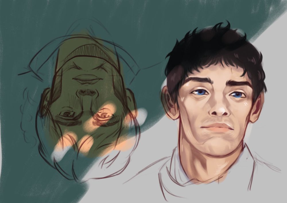 Merlin and Arthur from BBC’s Merlin. They’re both laying in the grass, shoulder up portrait, Merlin is right way up facing right and Arthur is upside down staring at the viewer