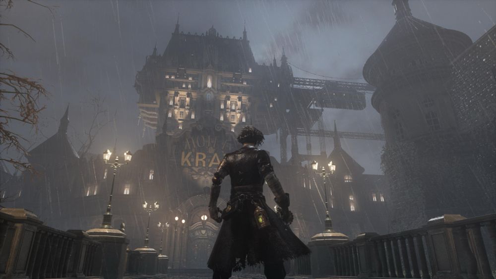 Moody screenshot from Lies of P, taken from behind the player character, looking up at the giant Hotel Krat in the distance. It's dark and misty outside.