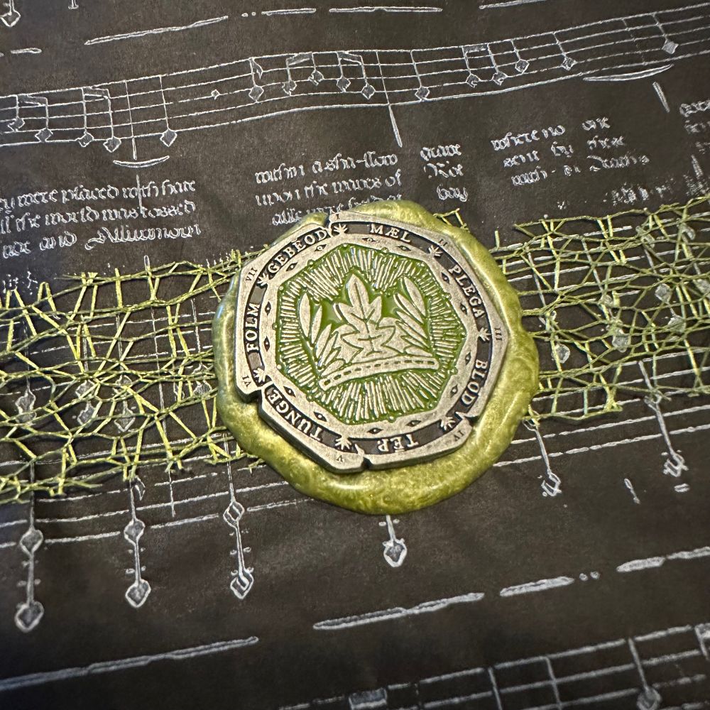 Close up of the Doom Coin, set in a wax seal on the books' packaging.