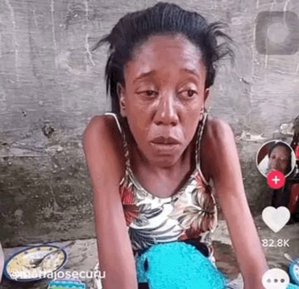 a woman is crying while sitting on the ground next to a clock .