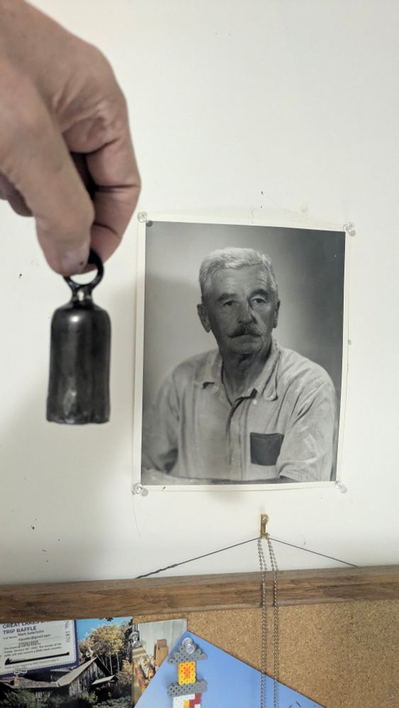 William Faulkner alongside a small bell.