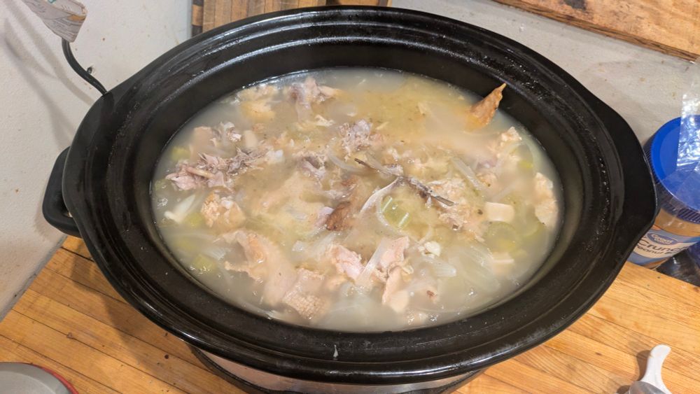 Crock Pot of chicken stock cooking 