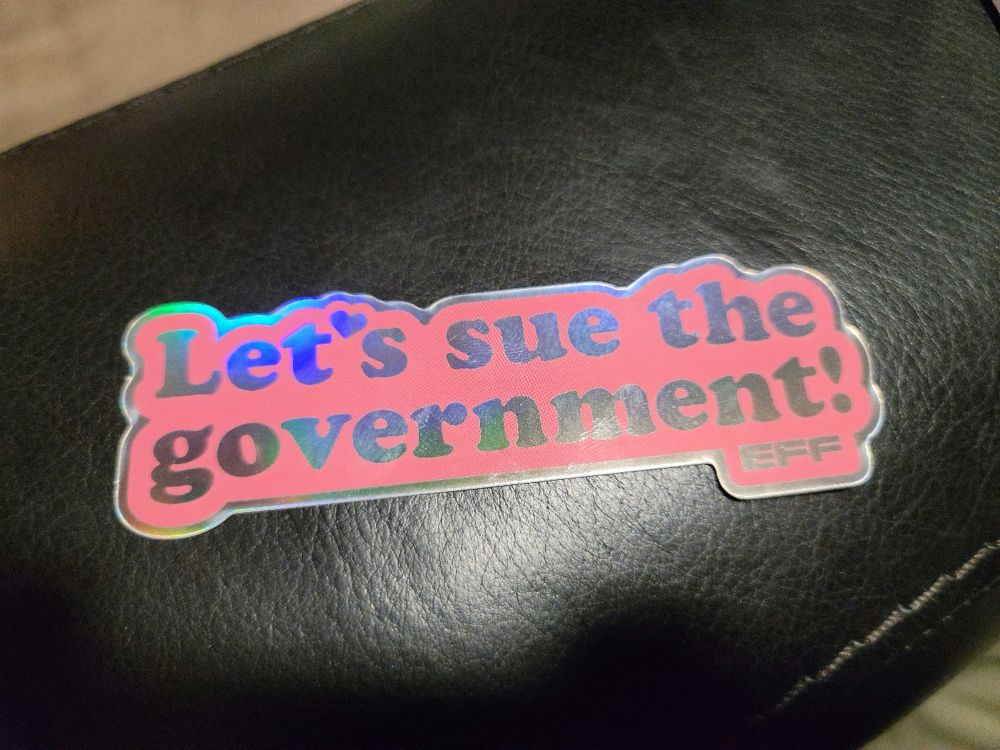 Sticker that says Let's sue the government! EFF
