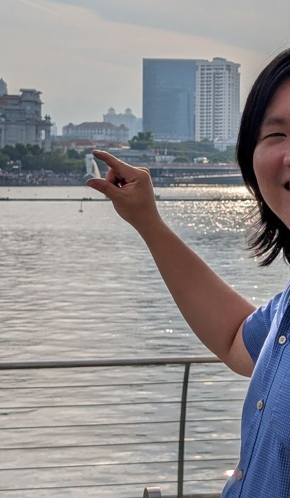 A photo of the Singapore Merlion being pinched from afar