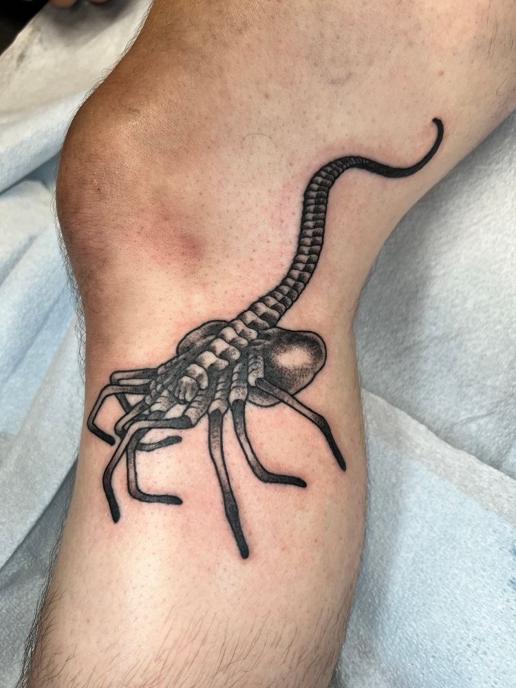 Black and grey stipple style alien facehugger tattoo by @TattoosByJakeb.