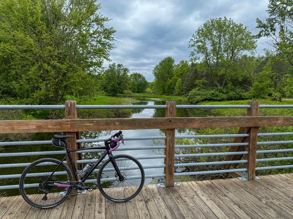 A Poseidon X bike leaning against a railing on a bridge. Michigan. 