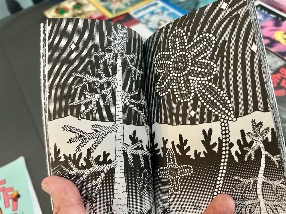 Spread from Cole Pauls’ comic—stark black and white with trees and beadwork plants.