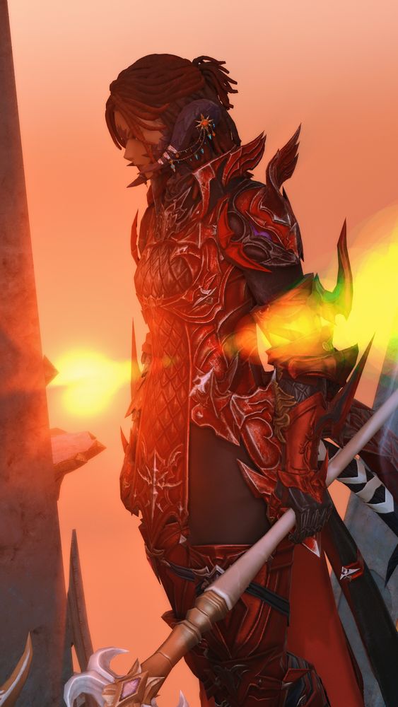 Avalan doing the iconic dragoon stance in a high place while the sun highlights her in the background