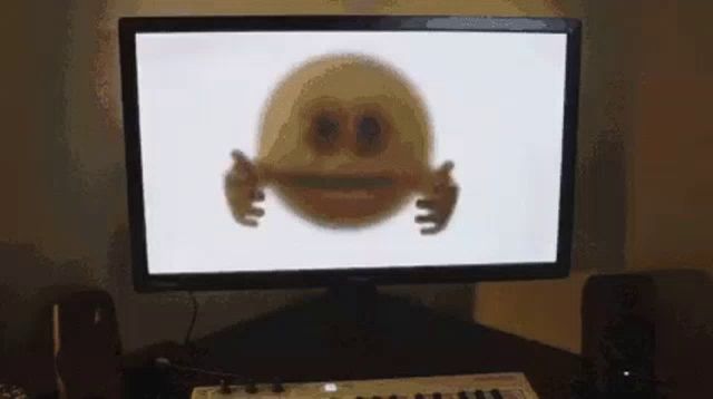 a computer monitor with a smiley face on the screen .