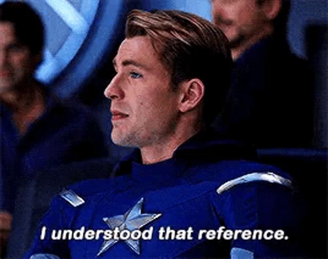 a man in a captain america uniform is sitting in a room and saying `` i understand that reference . ''