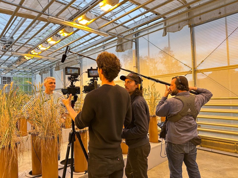 Malcolm Bennet in the greenhouse with the filming crew