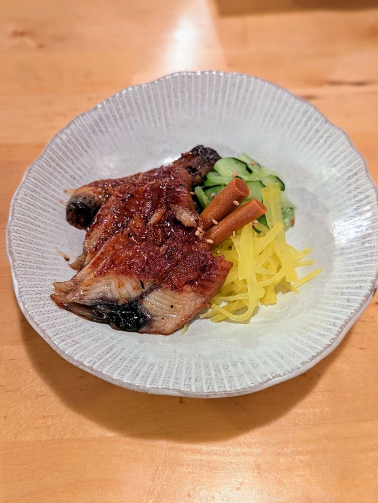 Braised eel with fresh mountain vegetables, including burdock root, grated mountain yam, and sliced cucumber. The vegetables were lightly salted and the eel was braised in soy sauce. 