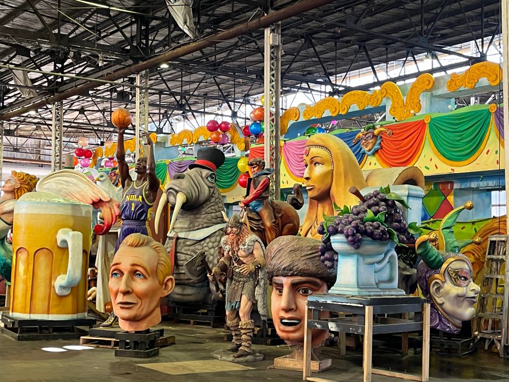 Seen at New Orleans’ Mardi Gras World: various colorful parts of floats, including a large beer mug, a walrus wearing a derby hat, and various human faces. 