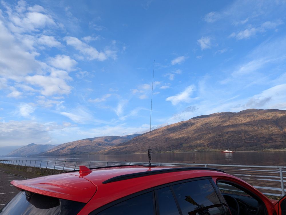 Car with a mag mount orbital CB antenna on top.