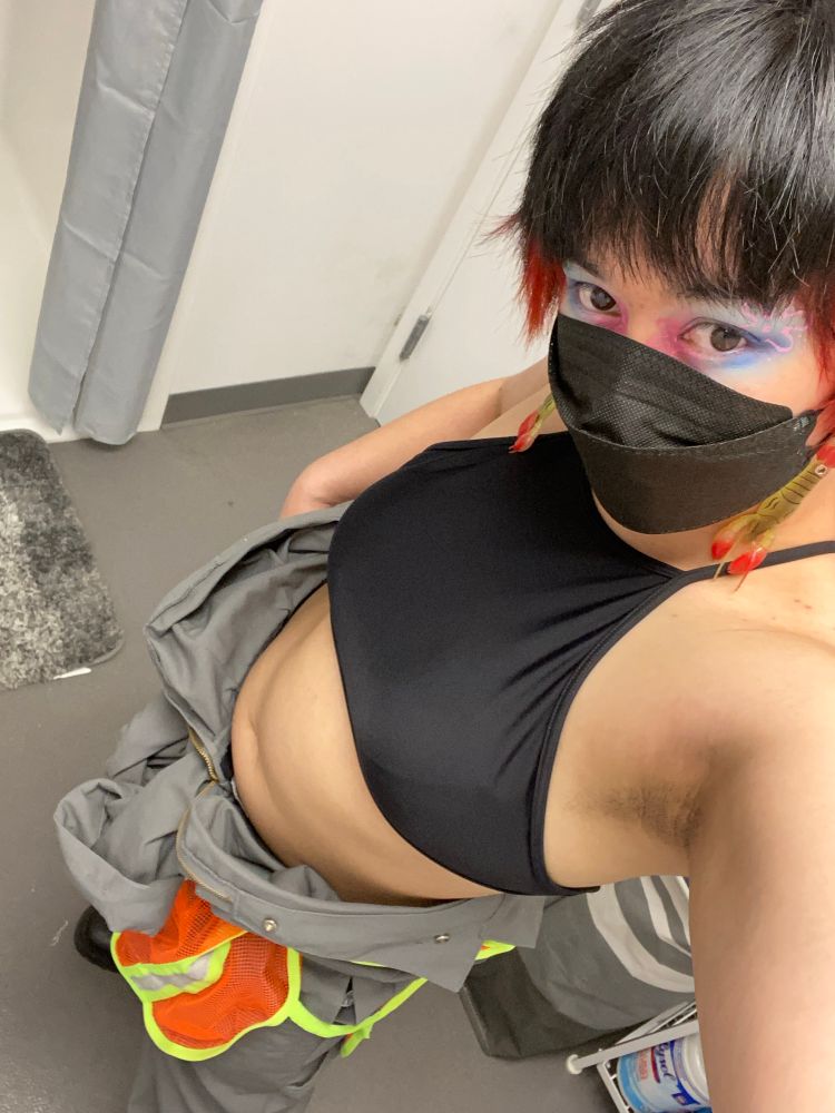 goth bitch stanced up in a worker jumpsuit costume half on like ellen ripley