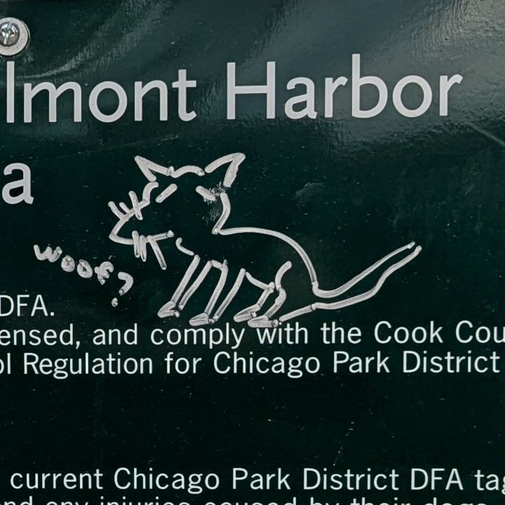 A digital photograph of graffiti, directly drawn on a dog park sign, depicting a strange dog like creature going "woof?"