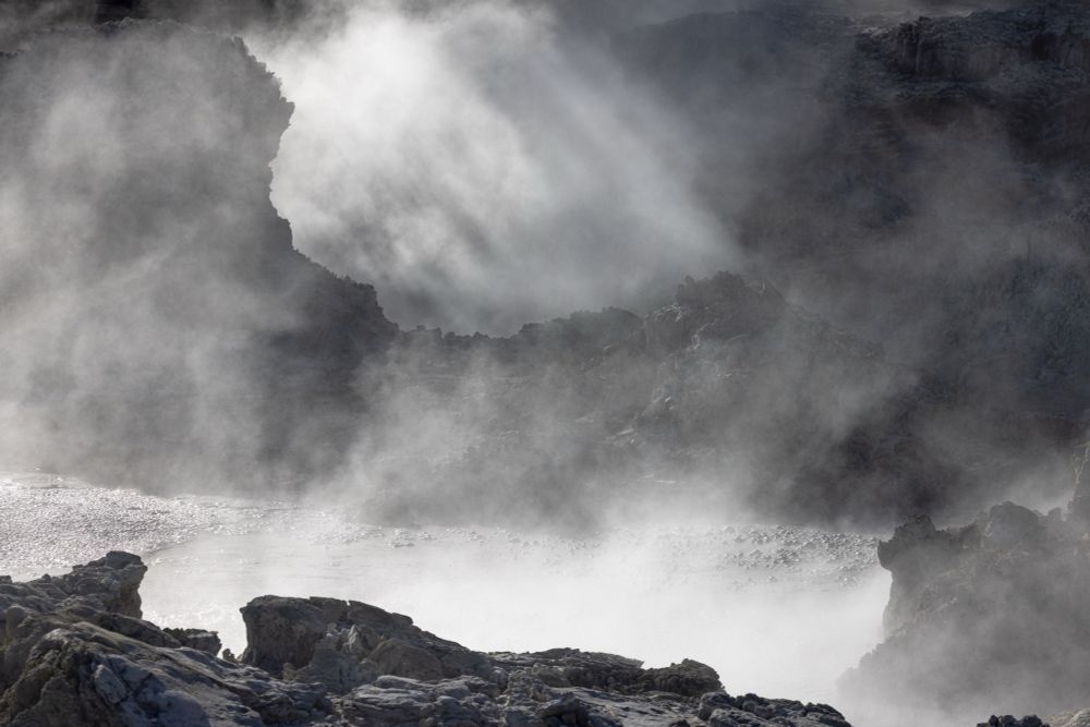 Steam rising from thermally heated pools. The photo is colour but the scene is monochromatic 