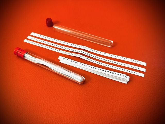 M138 Strip Cipher in clear plastic tube with red cap