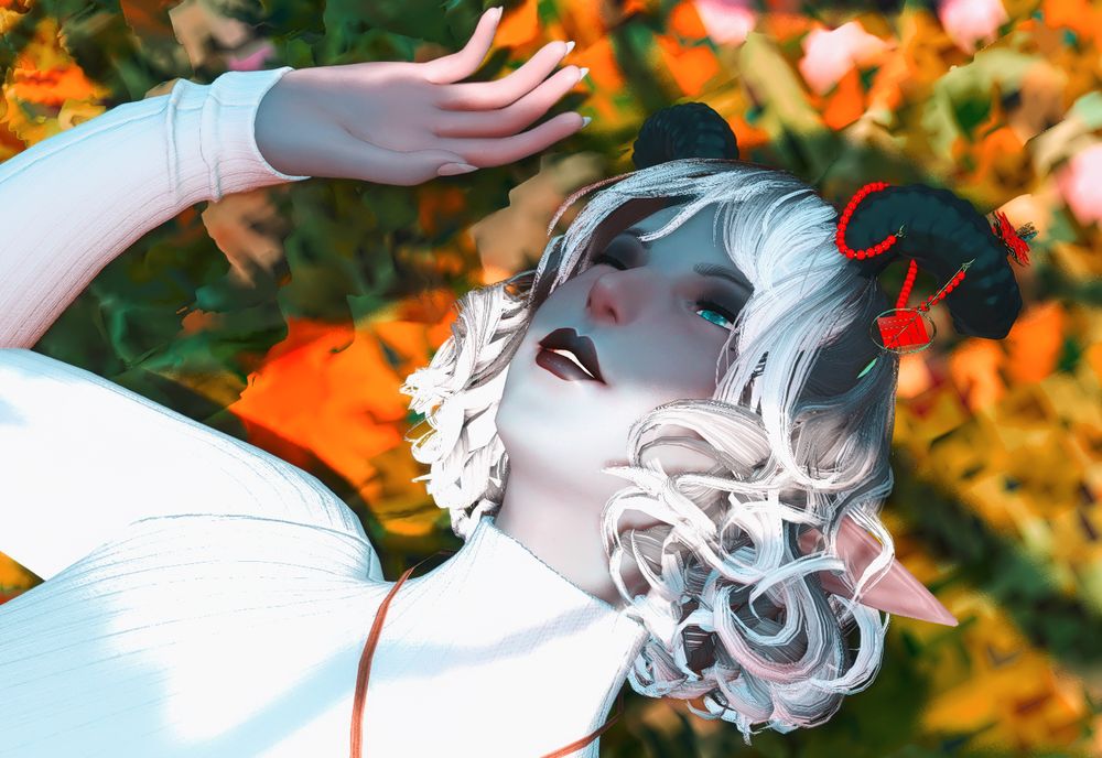 A Duskwight Elezen smiling and laying in the grass. Their eyes are softly closed, as if trying to protect their eyes from the sunlight.