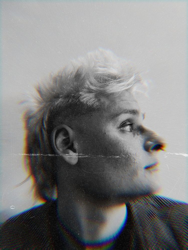 a edited black and white selfie of my face looking off camera (profile/