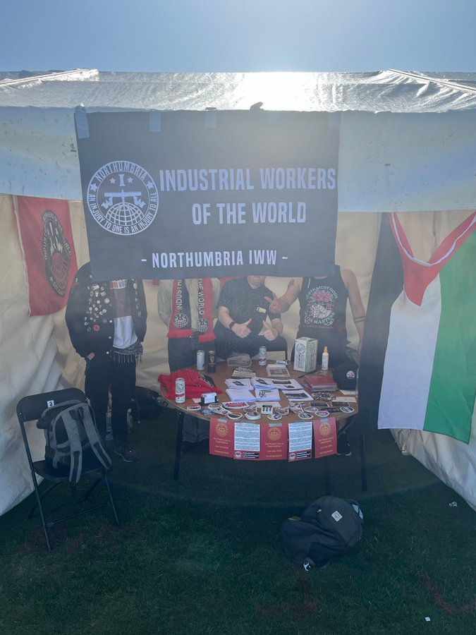 An IWW gazebo with four faceless individuals within 