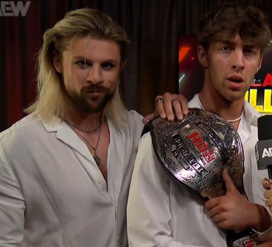 aew collision august 9th 2025. kip sabian and nick wayne during a backstage promo with kip's hand suspiciously over the roh title. the same title that nick won from komander