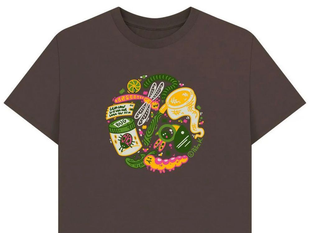 a brown t-shirt with a series of entomological themes in a circle, in light and dark green, yellow, pink and white. a rolly polly, a millipede, a dragonfly, an entomological label, a ladybug in a jar that says BUG, a caterpillar munching on a leaf, a bug under a magnifying glass, a bug net.